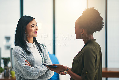 Buy stock photo Cropped shot of two young creatives having a discussion in an office