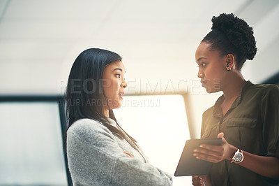 Buy stock photo Cropped shot of two young creatives having a discussion in an office