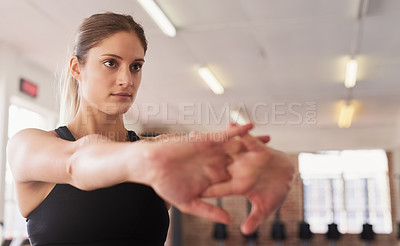 Buy stock photo Shot of a young woman doing static stretches before working out