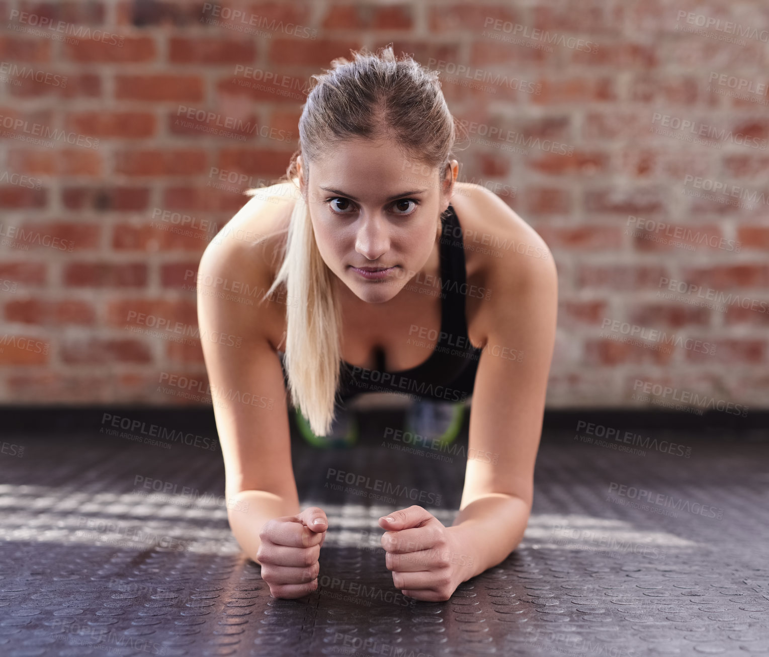 Buy stock photo Shot of a woman doing bodyweight exercises at the gym