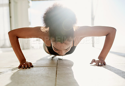 Buy stock photo Cropped shot of a sporty young woman doing push-ups outside