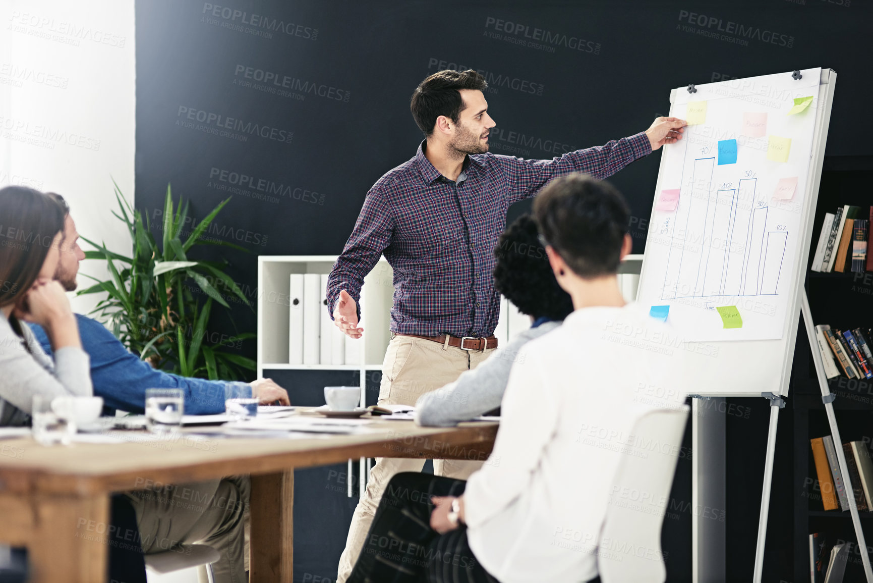 Buy stock photo Businessman, speaker and presentation with team in office from flip chart for feedback or review of company growth. Man, presenter and staff at seminar for strategy report, results or project data