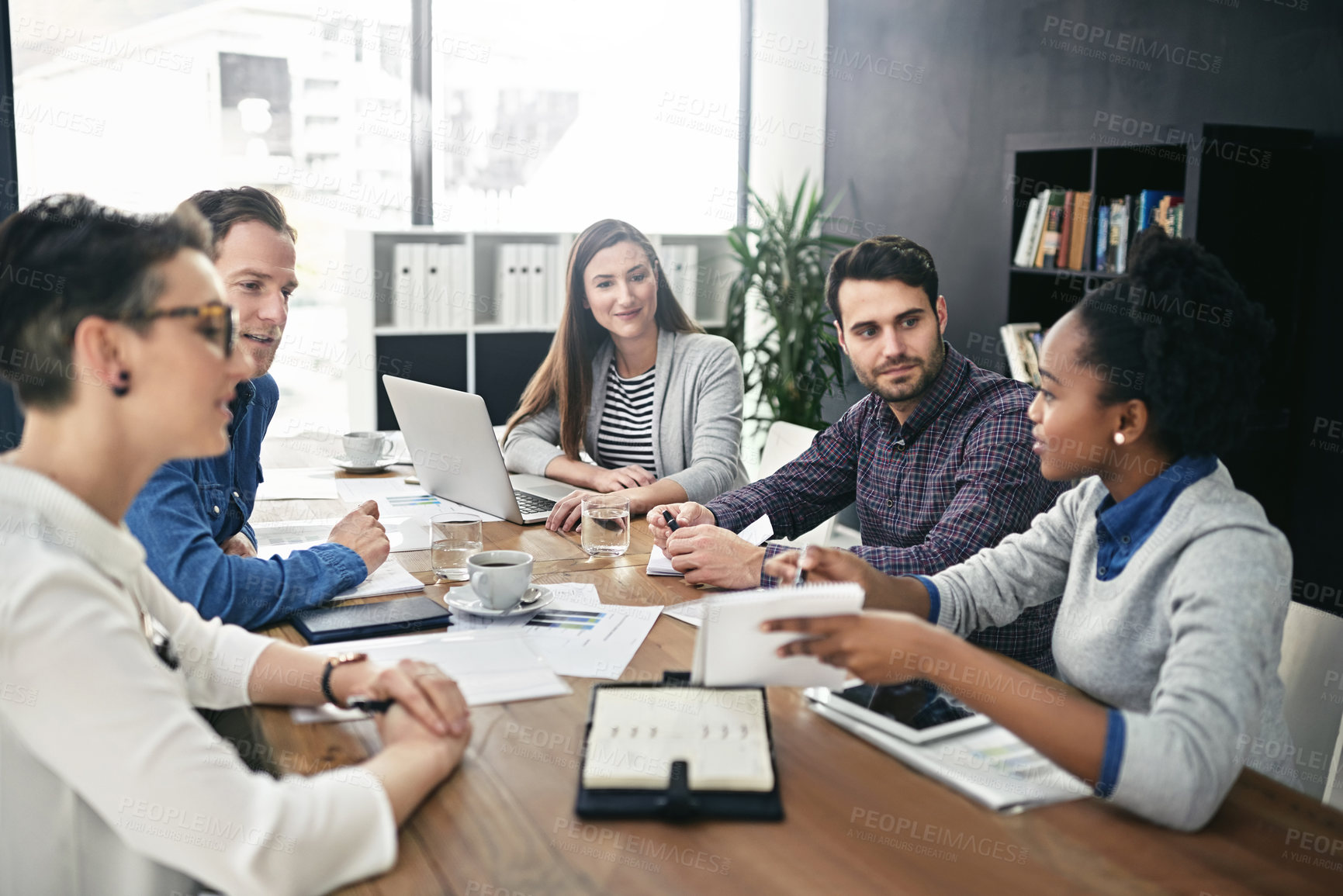 Buy stock photo Shot of a group of businesspeople having a meeting