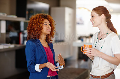 Buy stock photo Cropped shot of two colleagues having a discussion in an office