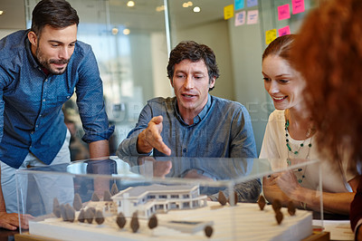 Buy stock photo Shot of a group of architects having a meeting in their boardroom