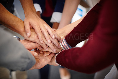 Buy stock photo Shot of a group of unidentifiable businesspeople piling their hands on top of each other