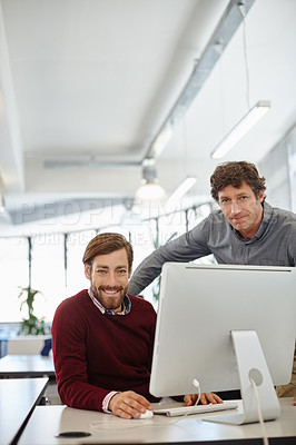 Buy stock photo Portrait of a businessman and his colleague working together on a computer in the office