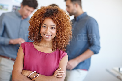 Buy stock photo Portrait of a businesswoman standing in the office with her colleagues in the background