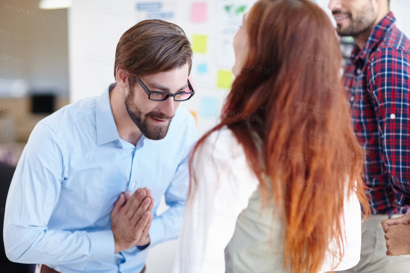 Buy stock photo Shot of a businessman bowing to his colleague at work