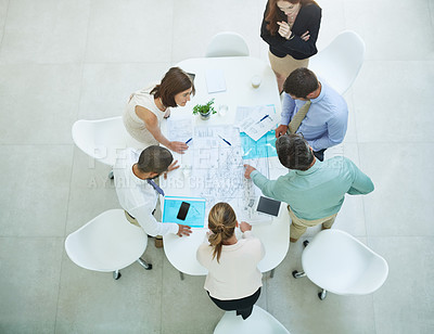 Buy stock photo High angle shot of a group of businesspeople meeting in the office