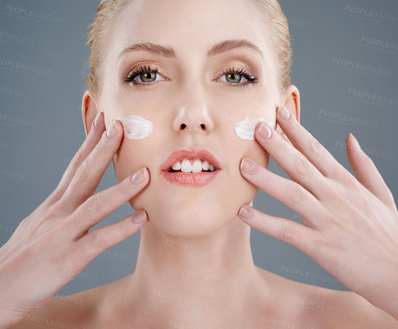 Buy stock photo Studio portrait of a young woman with beautiful skin isolated on gray