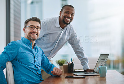 Buy stock photo Portrait of two businessmen working on a laptop in their office
