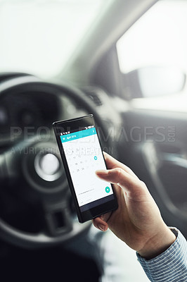 Buy stock photo Closeup shot of a driver using his cellphone in his car