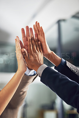 Buy stock photo Closeup shot of a group of colleagues giving each other a high five in an office