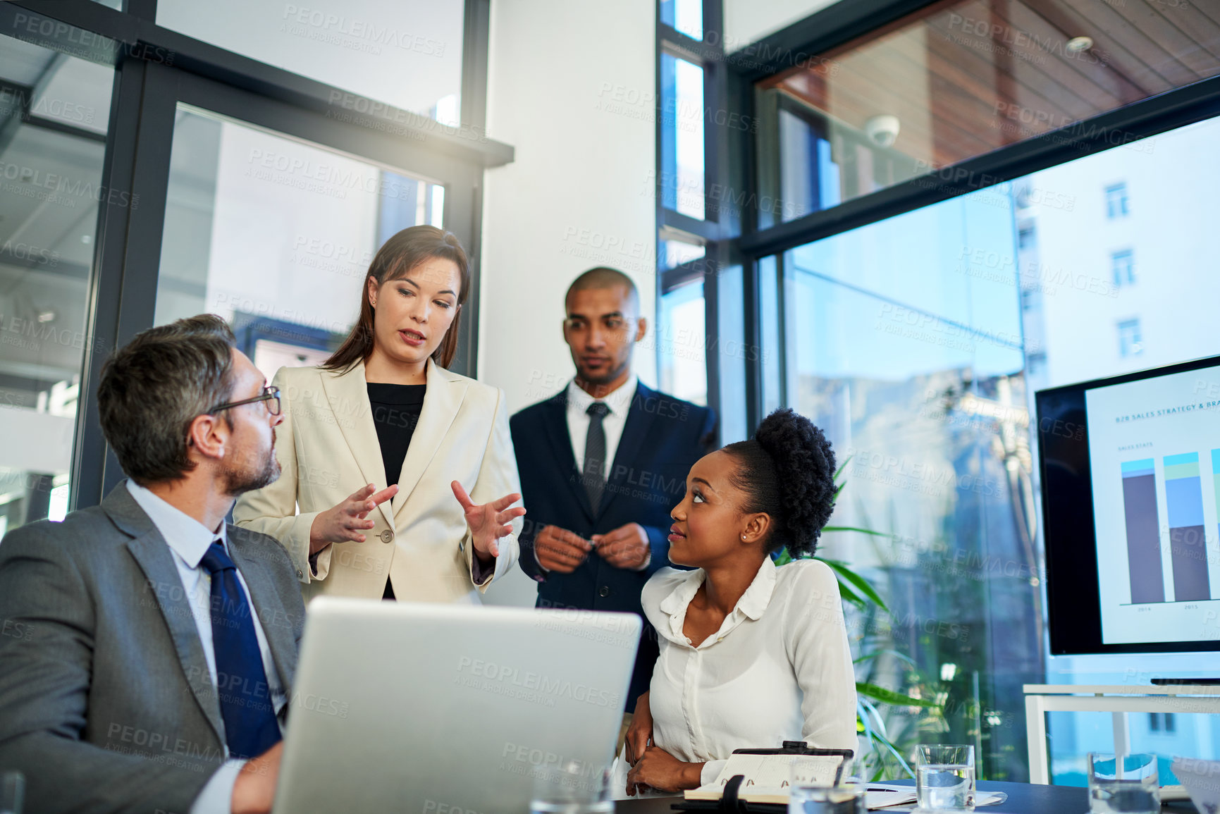 Buy stock photo Cropped shot of a group of business colleagues meeting in the boardroom