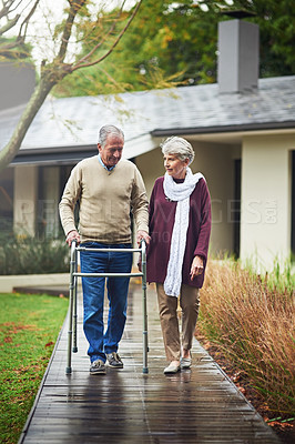 Buy stock photo Senior couple, garden and walker with chat, listen or together for love, bond or freedom in winter. Old woman, support and elderly person with disability in backyard, retirement or outdoor in morning
