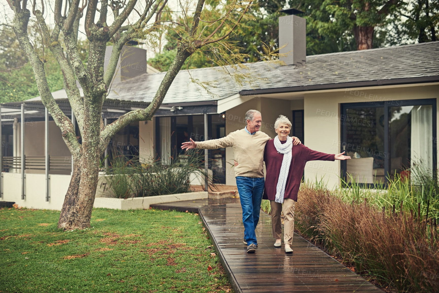 Buy stock photo Happy senior couple, garden and walk with smile, hug and together with love, bonding and freedom in winter. Old woman, happy man and embrace in backyard in retirement, nature and outdoor in morning