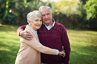 Buy stock photo Portrait of an affectionate senior couple enjoying some time outside