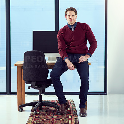 Buy stock photo Portrait of a young designer sitting on his work station desk in front of a window