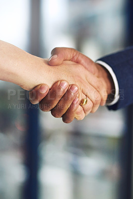 Buy stock photo Cropped shot of a businessman and businesswoman shaking hands at work