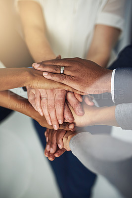 Buy stock photo Cropped shot of a team of colleagues joining their hands together in unity