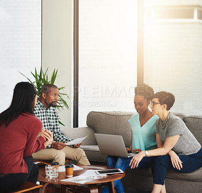 Buy stock photo Shot of a group of colleagues working together on a laptop