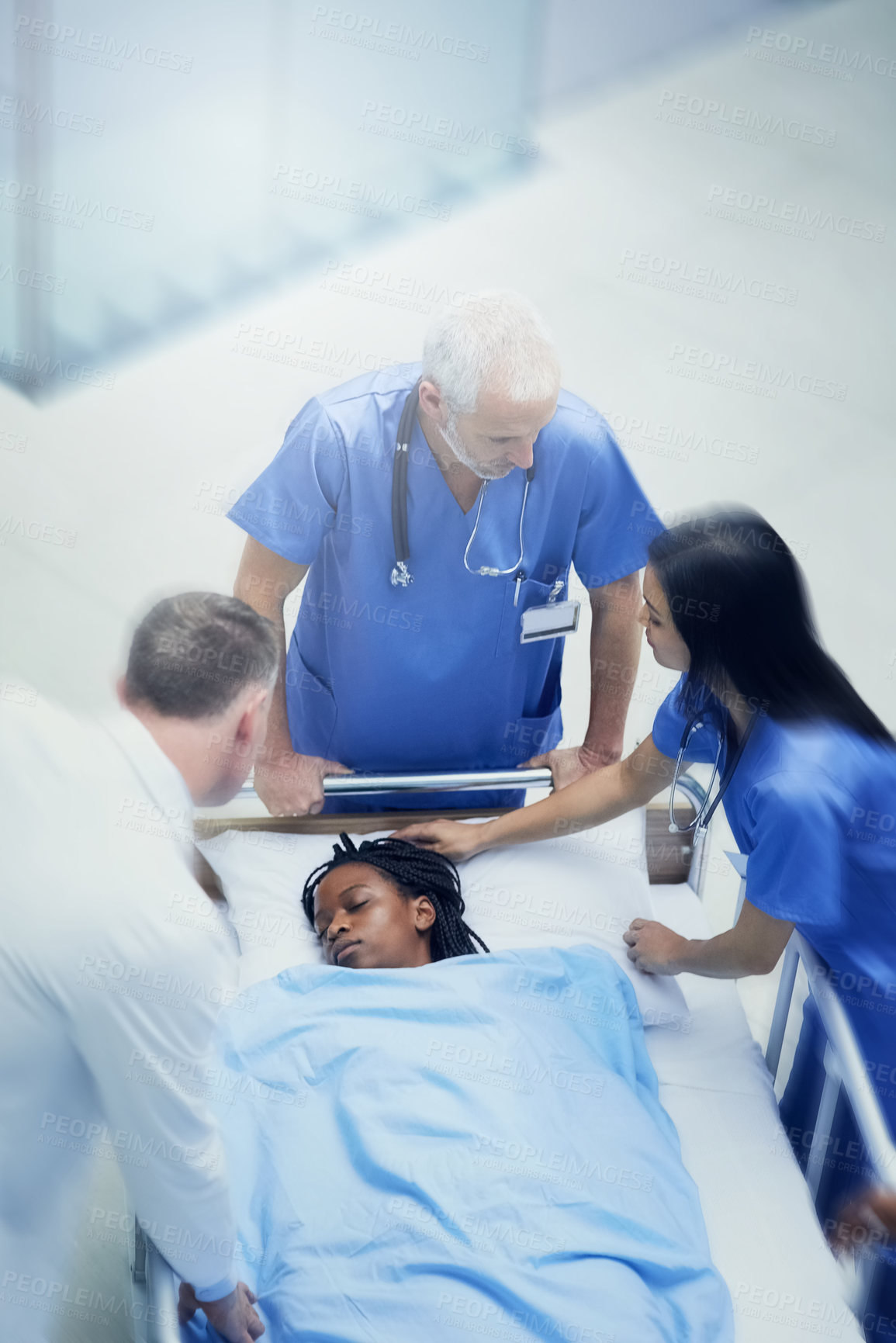 Buy stock photo Doctors, woman and patient rush for emergency surgery of accident or injury, trauma and urgency for critical condition. Medical staff or team, run and fast for resuscitation, healthcare and theatre.