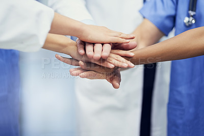 Buy stock photo Closeup shot of a group of medical professionals standing in a huddle with their hands together