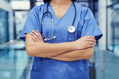 Buy stock photo Portrait of a young female doctor standing with her arms crossed in a hospital