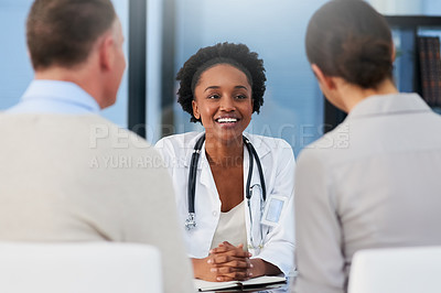 Buy stock photo Cropped shot of a female doctor talking to a married couple in her office