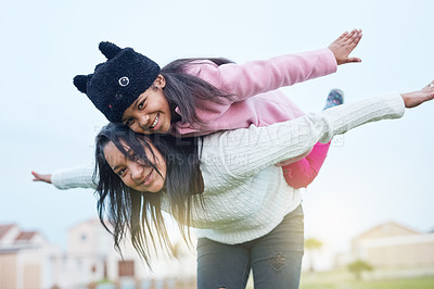 Buy stock photo Shot of a mother and daughter playing a game outside