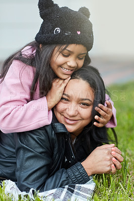 Buy stock photo Cropped shot of a little girl playing with her mother's hair outside