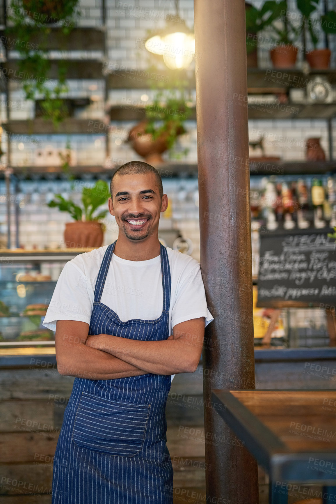 Buy stock photo Portrait of a young entrepreneur standing in his business