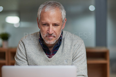 Buy stock photo Serious, businessman and laptop in office with pride, corporate and working at night for project. Technology, mature male person and director in workplace for online, email and reading ebook at desk