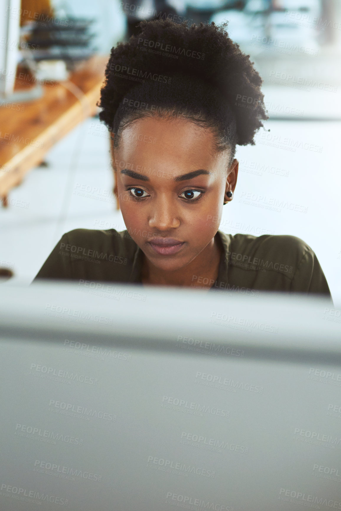 Buy stock photo Cropped shot of a young businesswoman working on a computer in a modern office