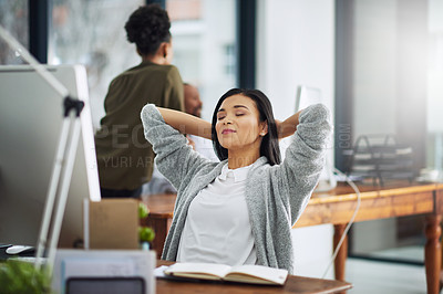 Buy stock photo Cropped shot of a young businesswoman taking a break at her desk