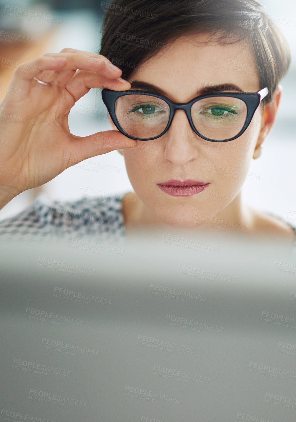 Buy stock photo Cropped shot of a young businesswoman working on a computer in an office