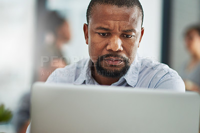 Buy stock photo Cropped shot of a mature businessman working on a computer in an office