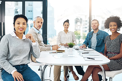 Buy stock photo Portrait of a group of colleagues sitting together in a boardroom