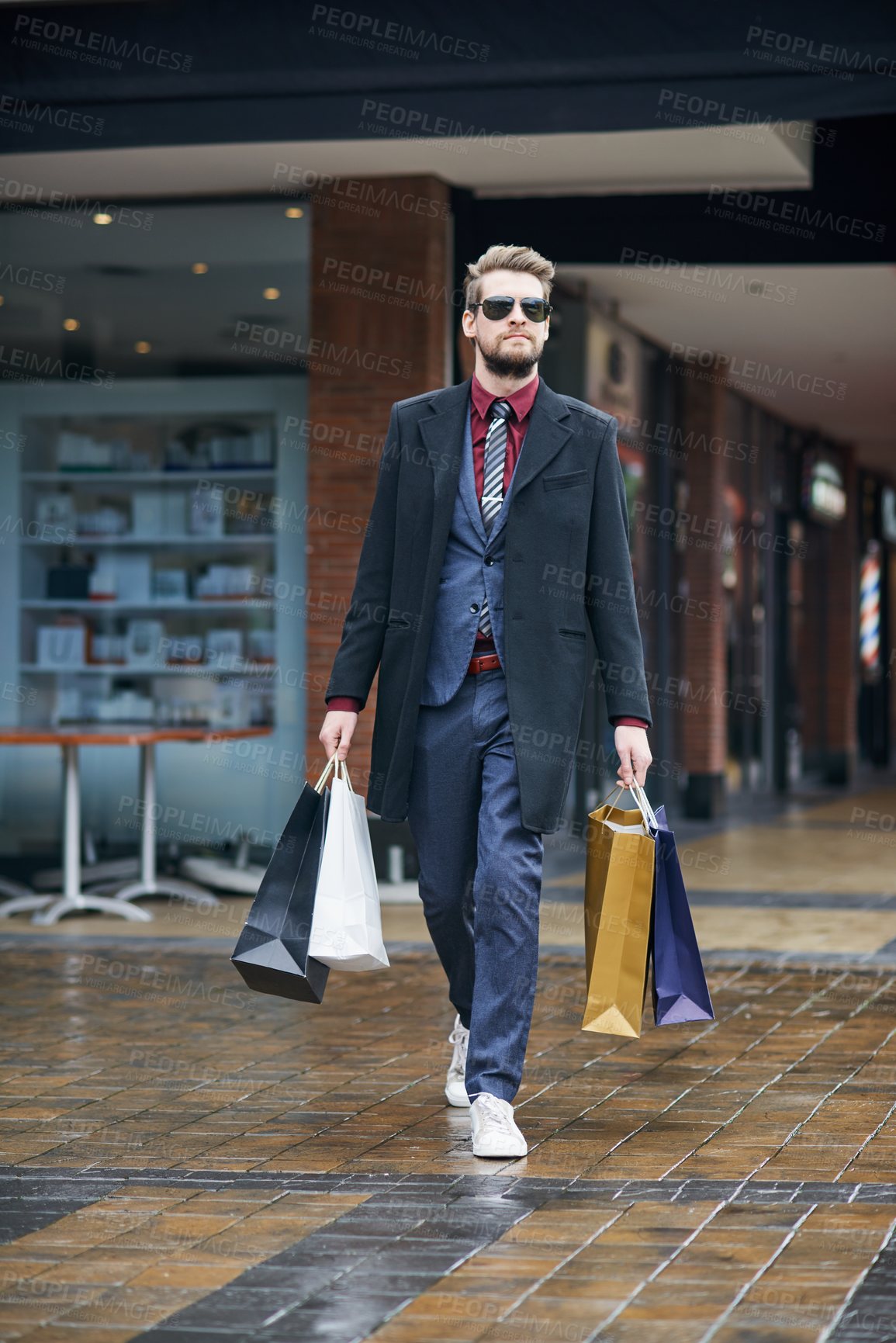 Buy stock photo Man, shopping bags and formal clothes at mall, walking and customer or shopper, discount and retail. Boutique, sale and spree in sunglasses, suit and purchase in product, deal and stylist in city