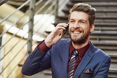 Buy stock photo Portrait of a happy young businessman using his phone while out in the city