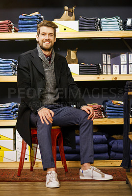 Buy stock photo Portrait of a happy young man sitting in a clothing boutique