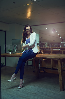 Buy stock photo Portrait of a young businesswoman working late in an office
