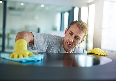 Buy stock photo Man with gloves cleaning surface in office, health and hygiene in workplace, janitor at clean desk. Professional cleaner wiping table in workplace, maintenance and disinfectant on cloth for germs.