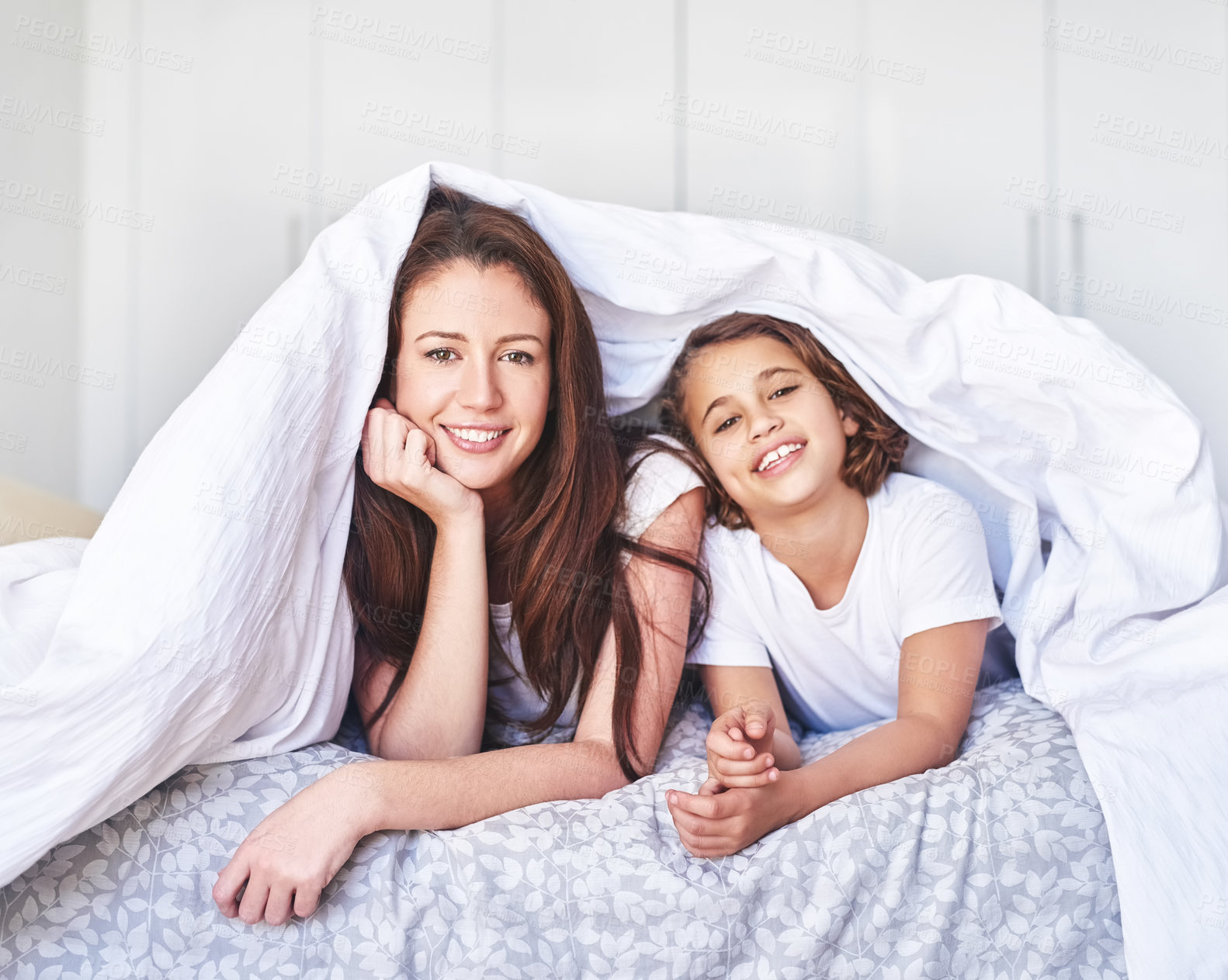 Buy stock photo Portrait of a mother and daughter relaxing together at home in the morning