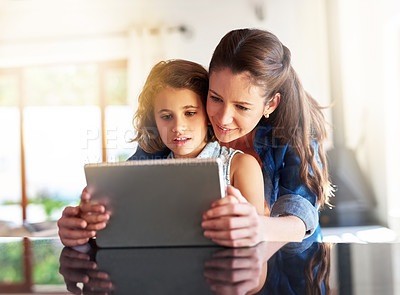Buy stock photo Girl, Mother and tablet in apartment for elearning, education and connection in family home. Mom, young girl and technology in house for social network, online streaming and play games on weekend 