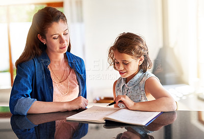 Buy stock photo Cropped shot of a mother helping her daughter with her homework