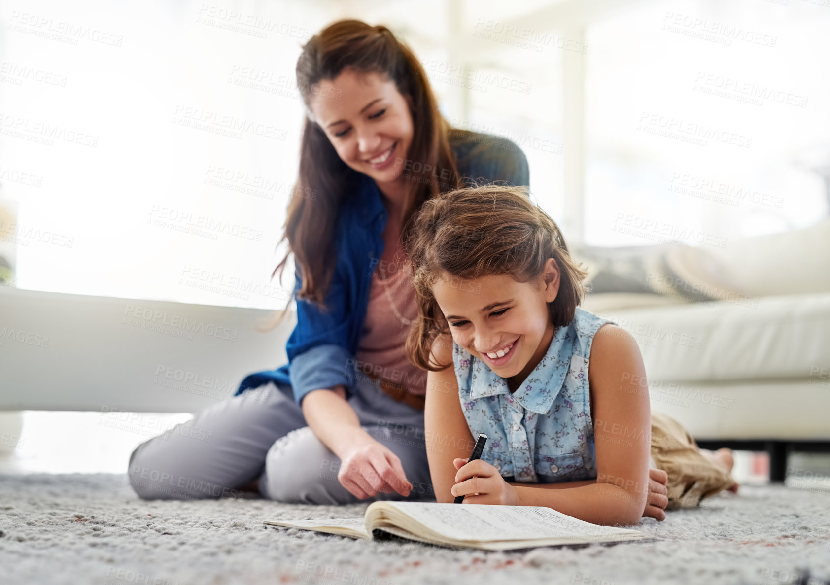 Buy stock photo Mother, girl and help with book on floor for learning, homeschool and writing for essay or english literature assignment. Mom, daughter and together on mat in home for education and knowledge.