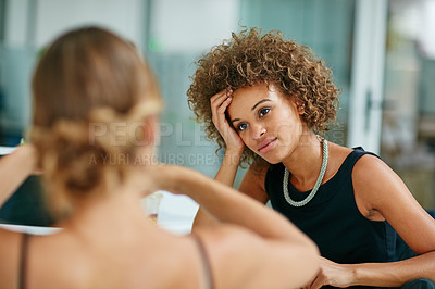 Buy stock photo Shot of two coworkers talking together while sitting in a modern office