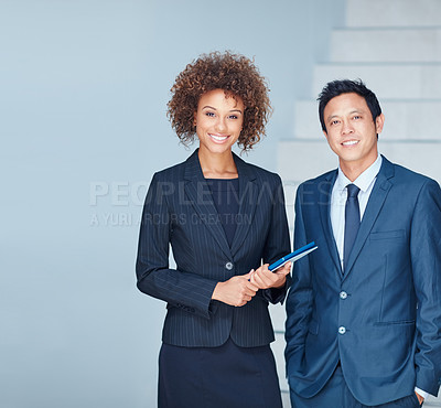 Buy stock photo Portrait of two corporate businesspeople standing together in an office